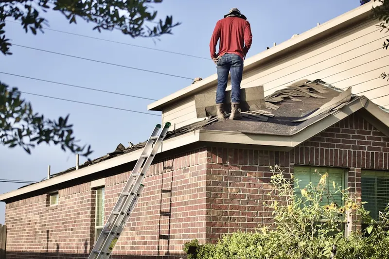 Professional roofer working on a residential roof in Beach Park